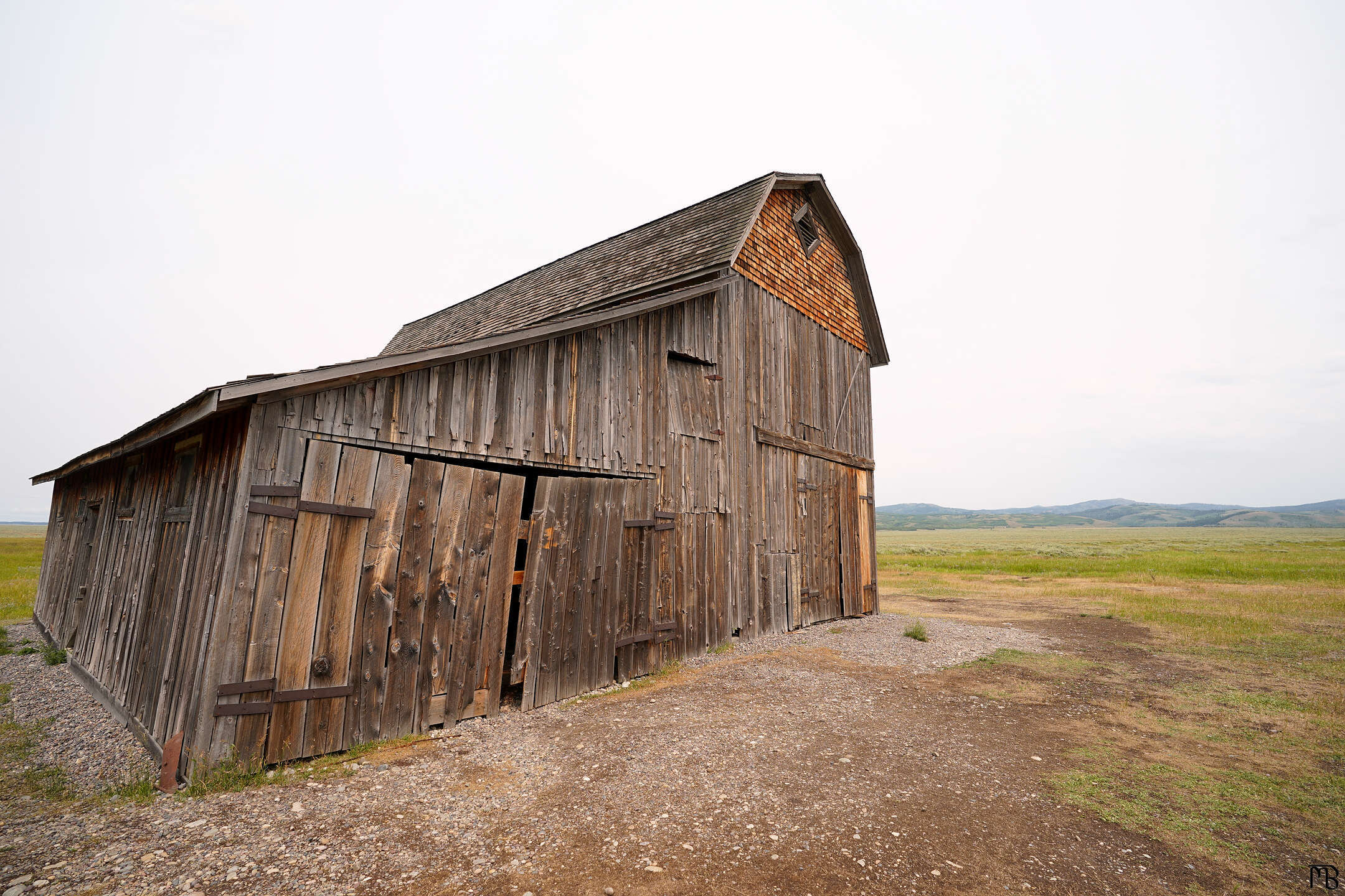 Old barn with mountains in the background