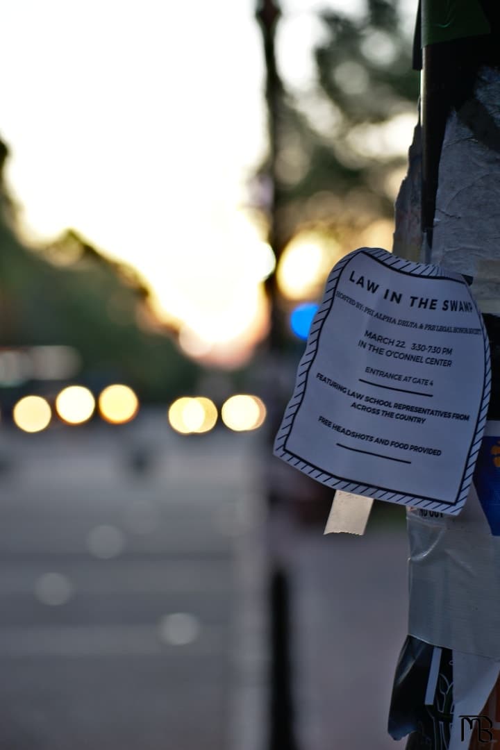 Flyer on metal pole against sun set