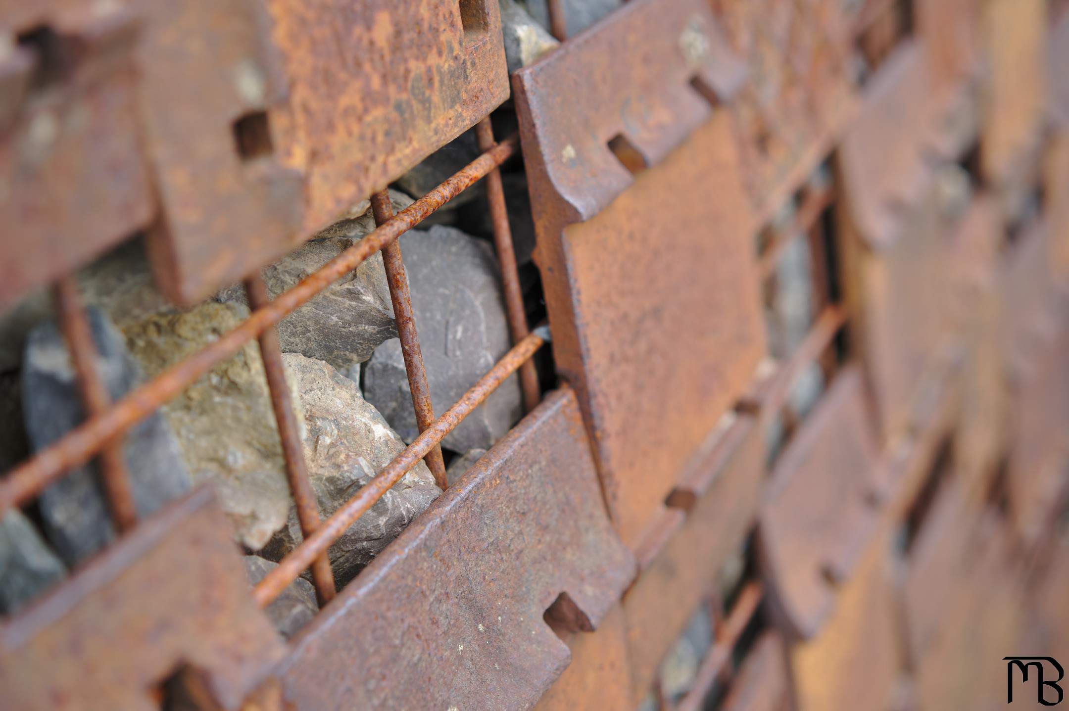 Rusty metal holding back rocks