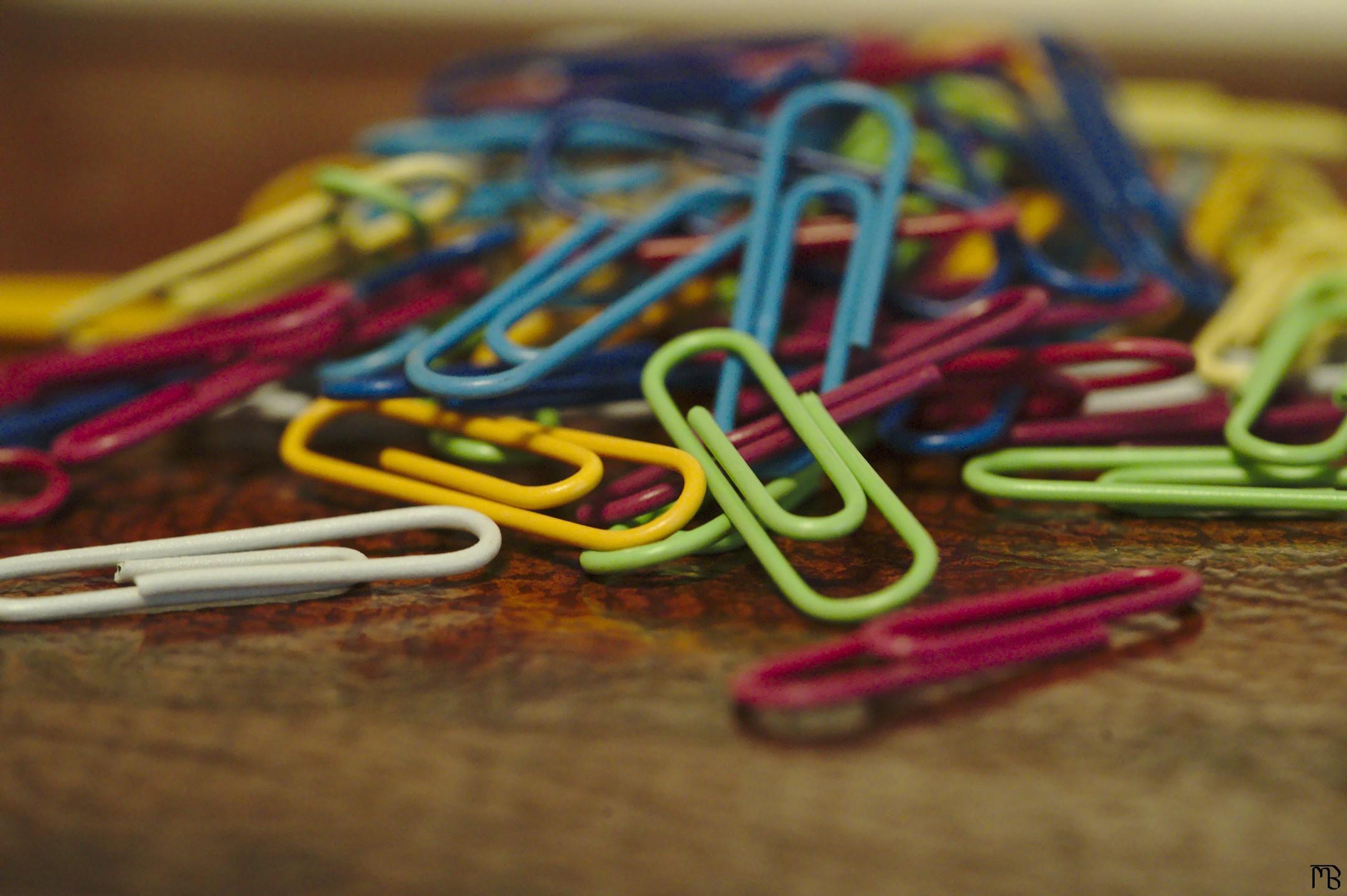 Colored paper clips on desk