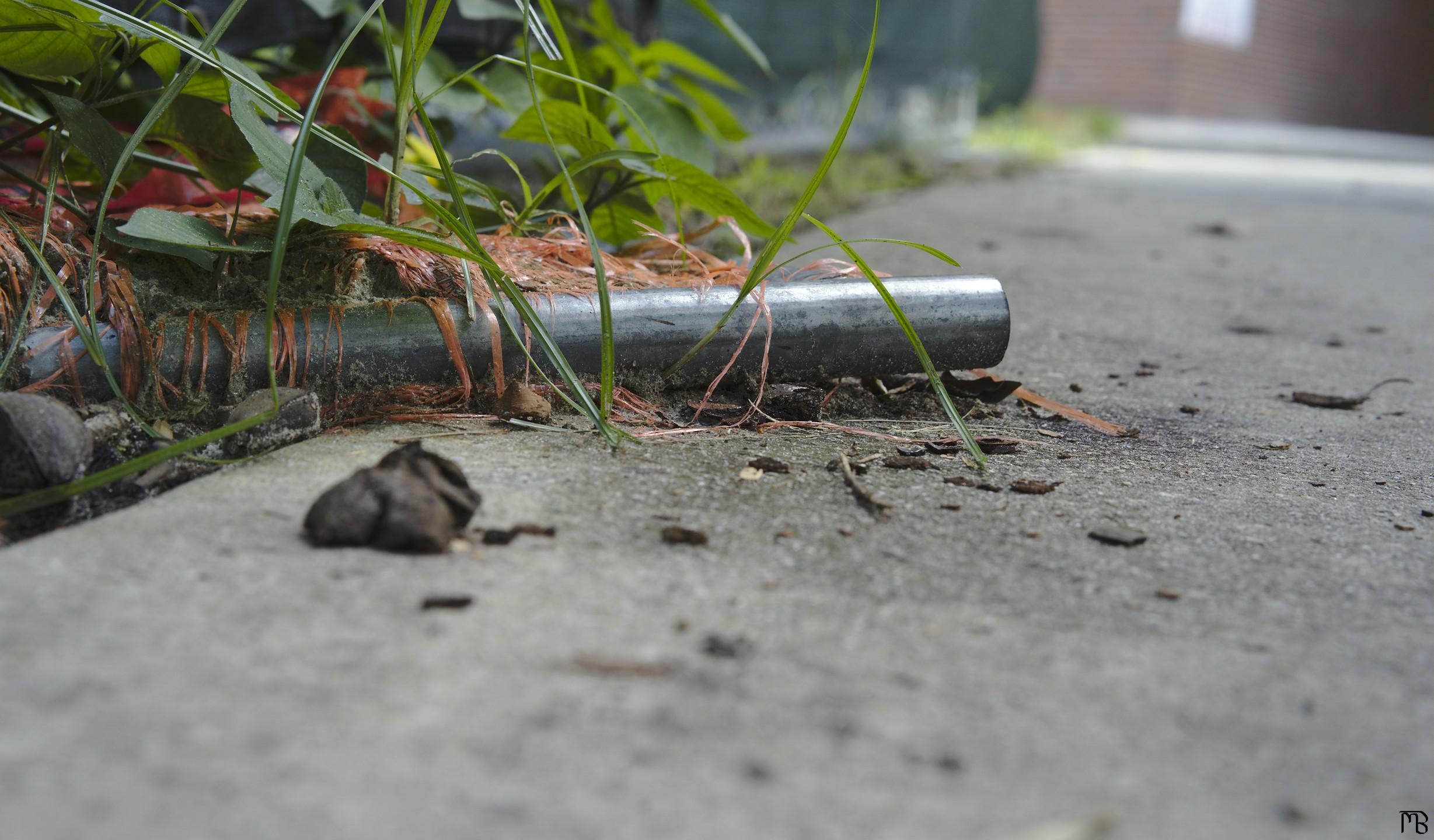 Pole lying on side walk