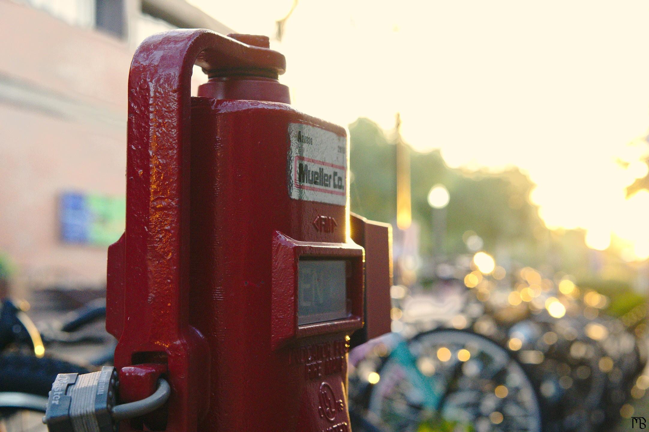 Red bike pump near bike racks