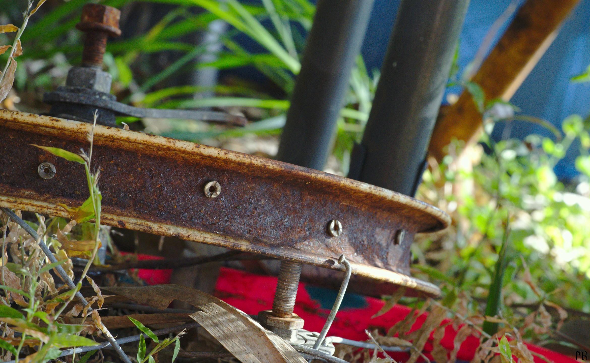 Rusty bike wheel in grass