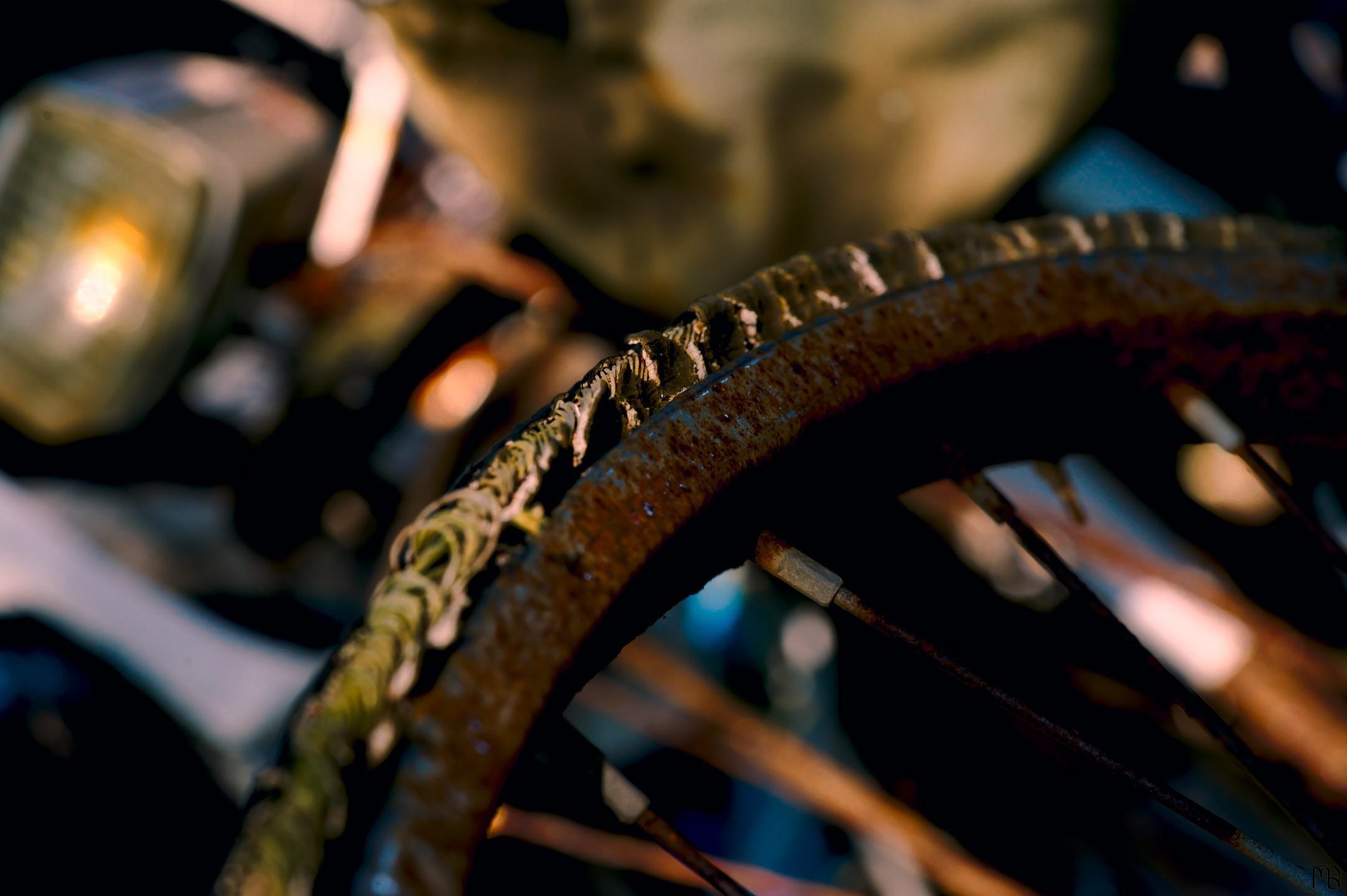 Arty yellow bike wheel and blue bike