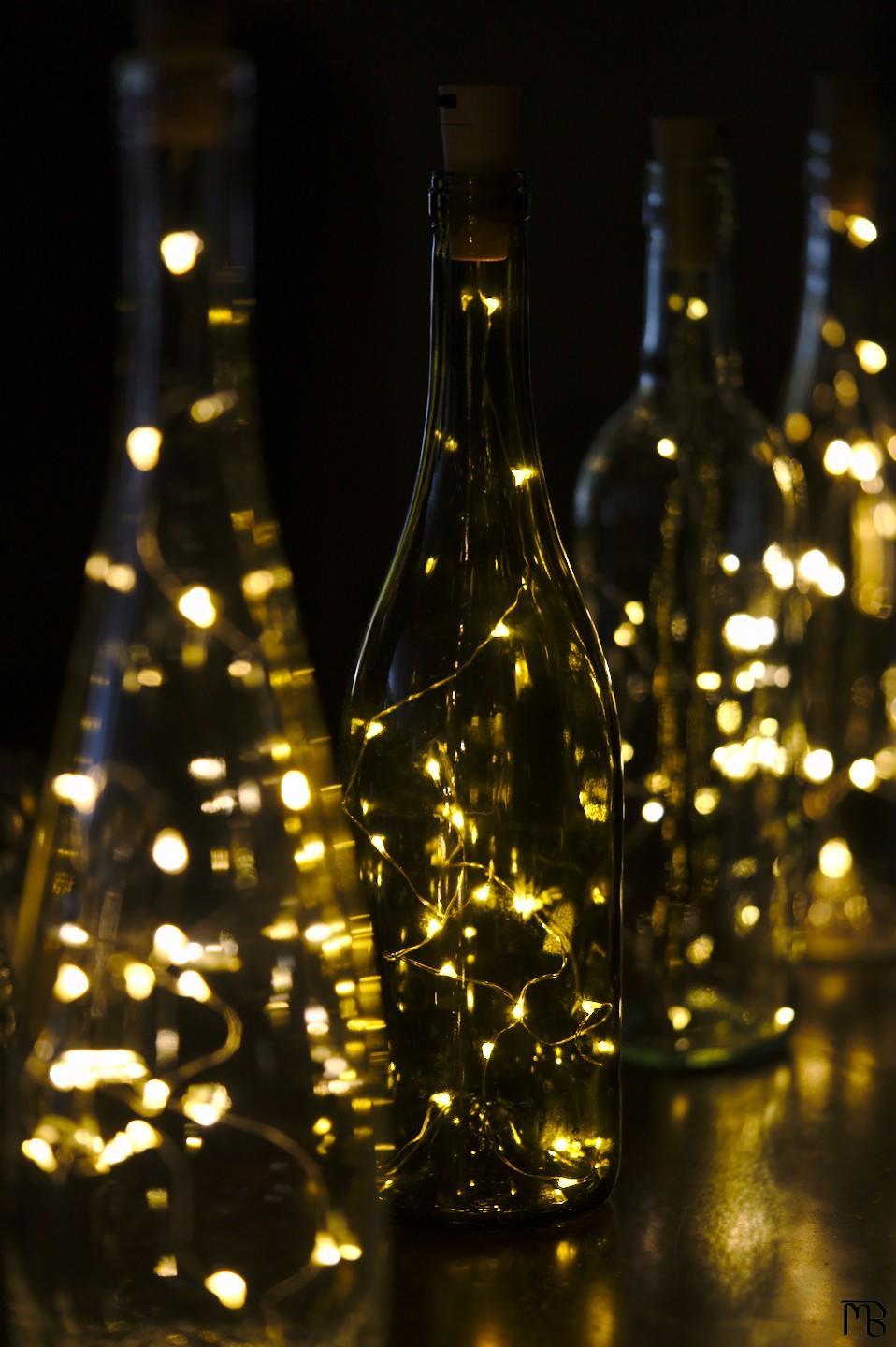 Four bottles with yellow lights