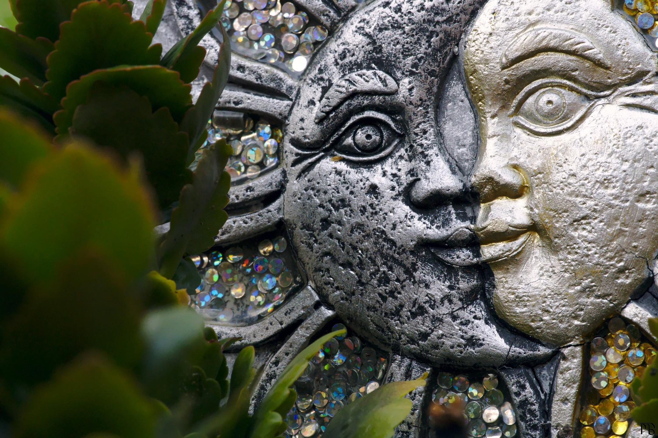 Sun and moon scuplture in plant pot