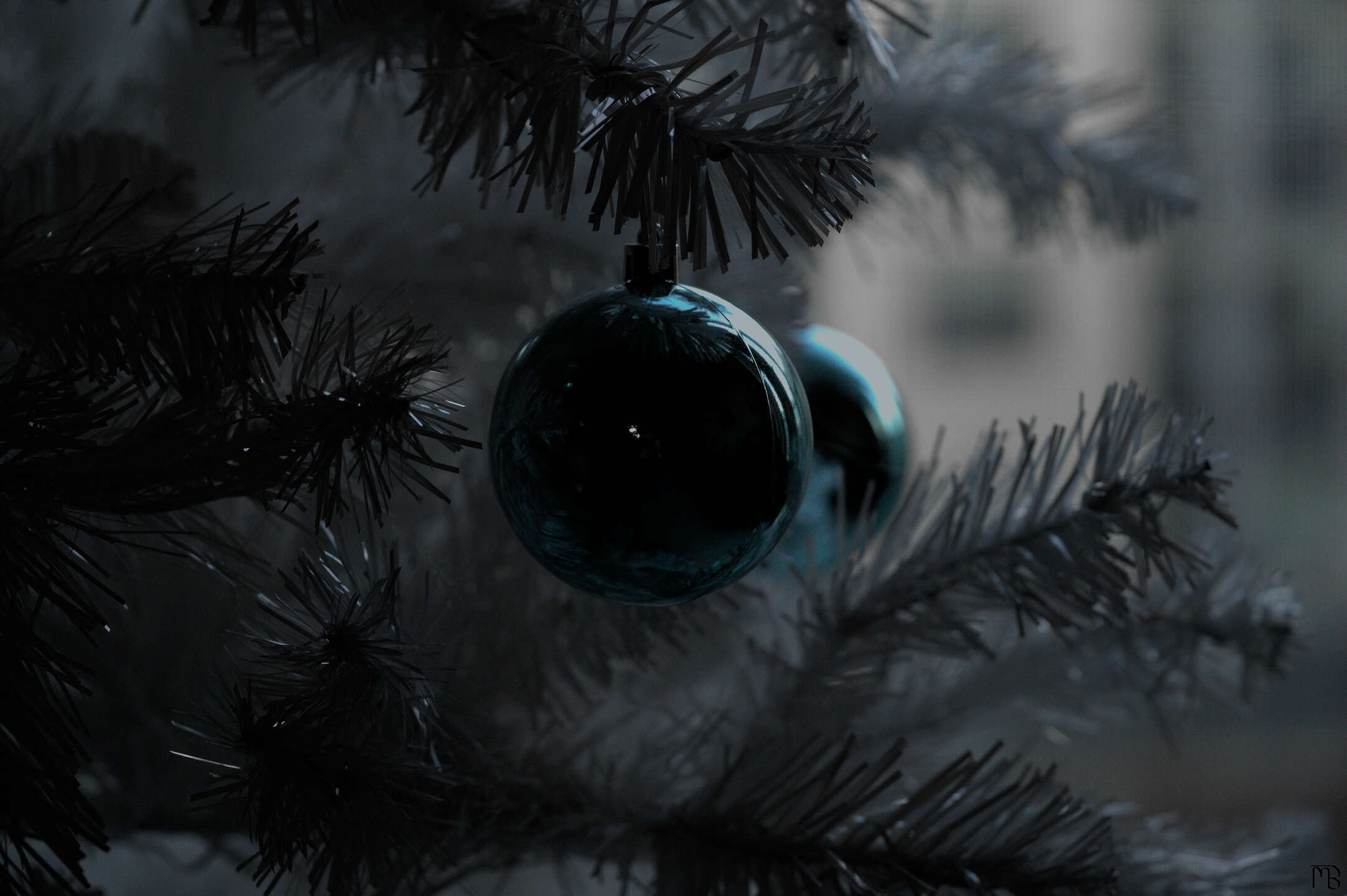 Black out blue ornament on white tree