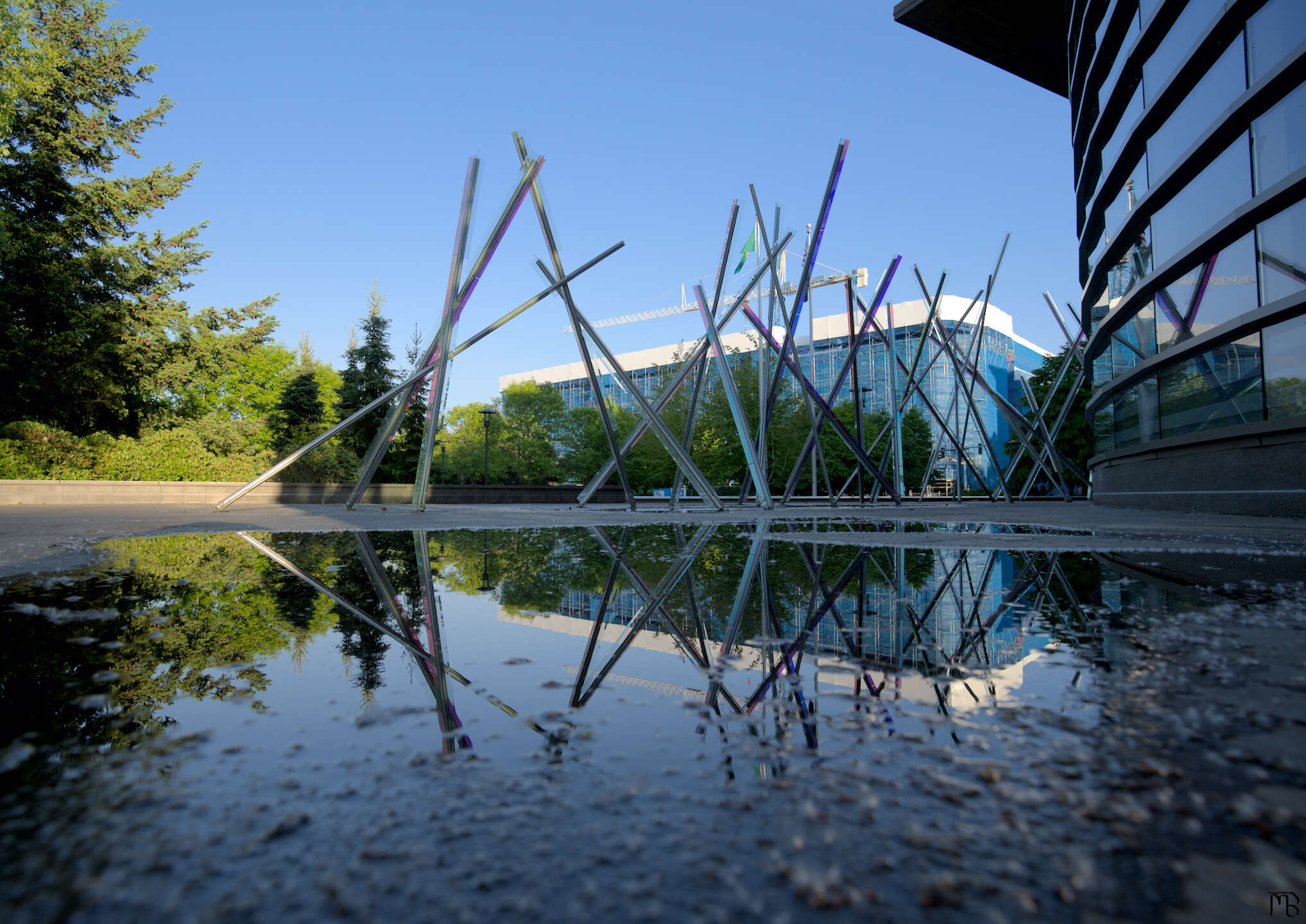 Art statue reflected in puddle