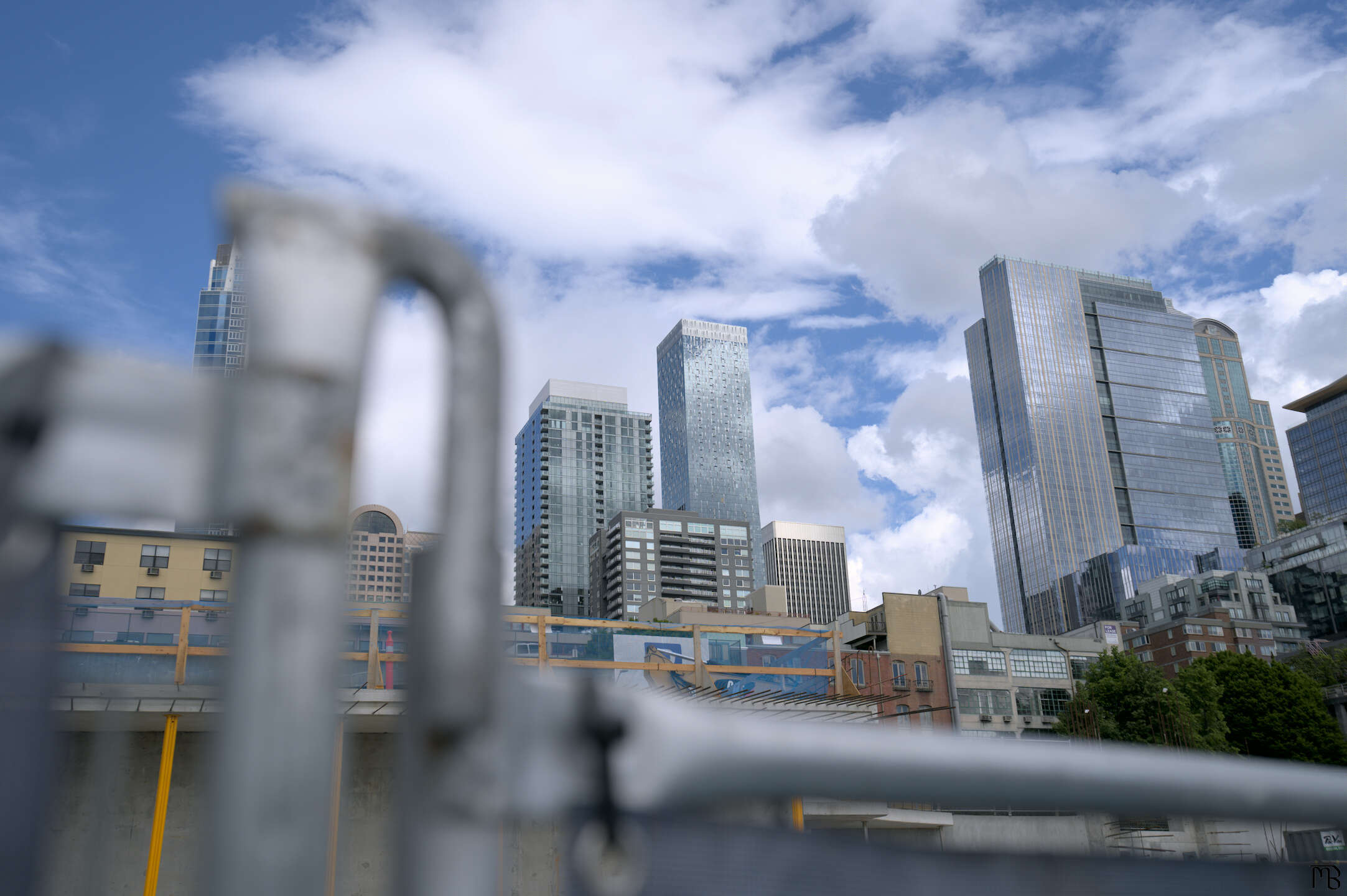 Some skyscrapers above a metal fence