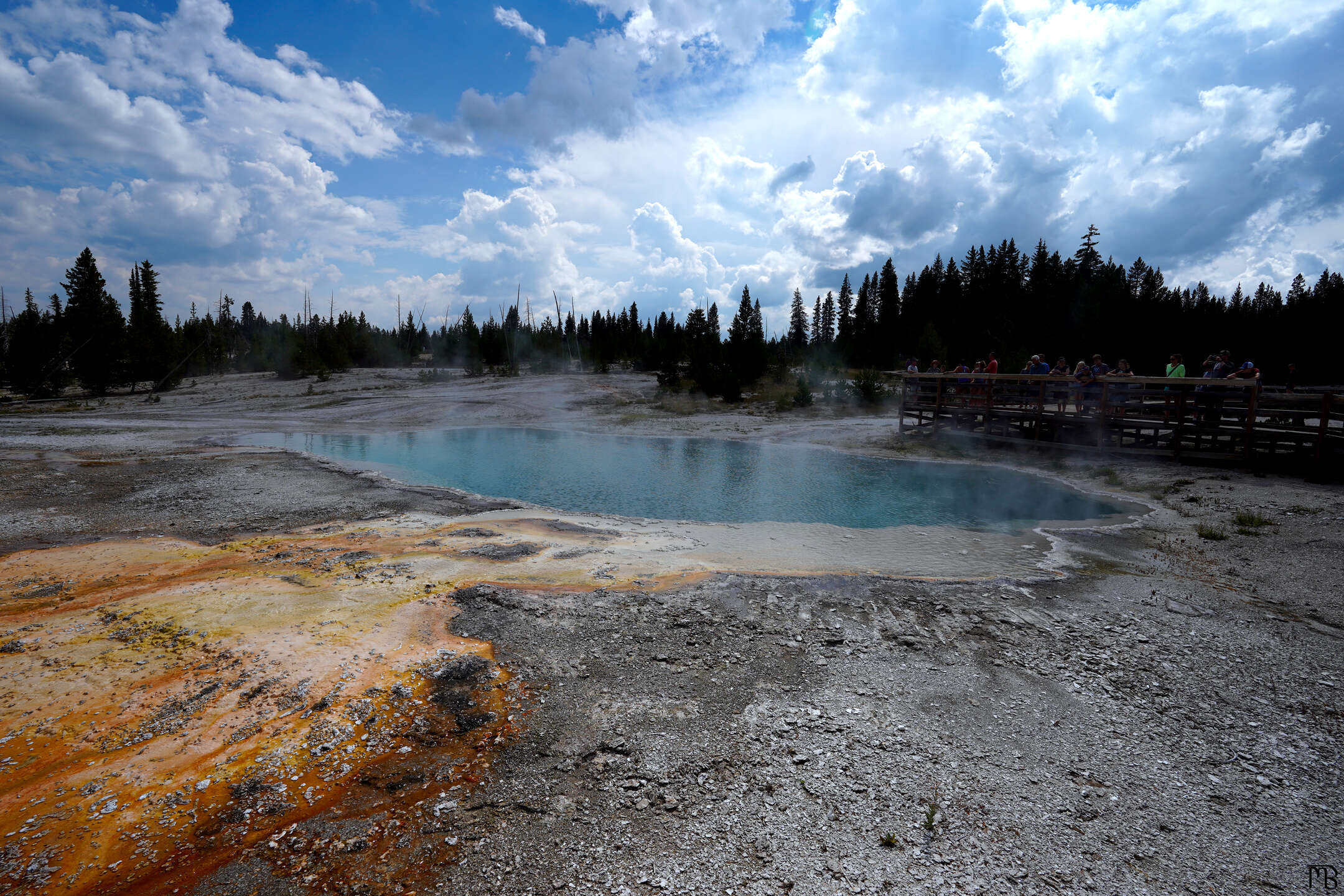 Orange hot spring run off flowing into blue hot spring at Yellowstone