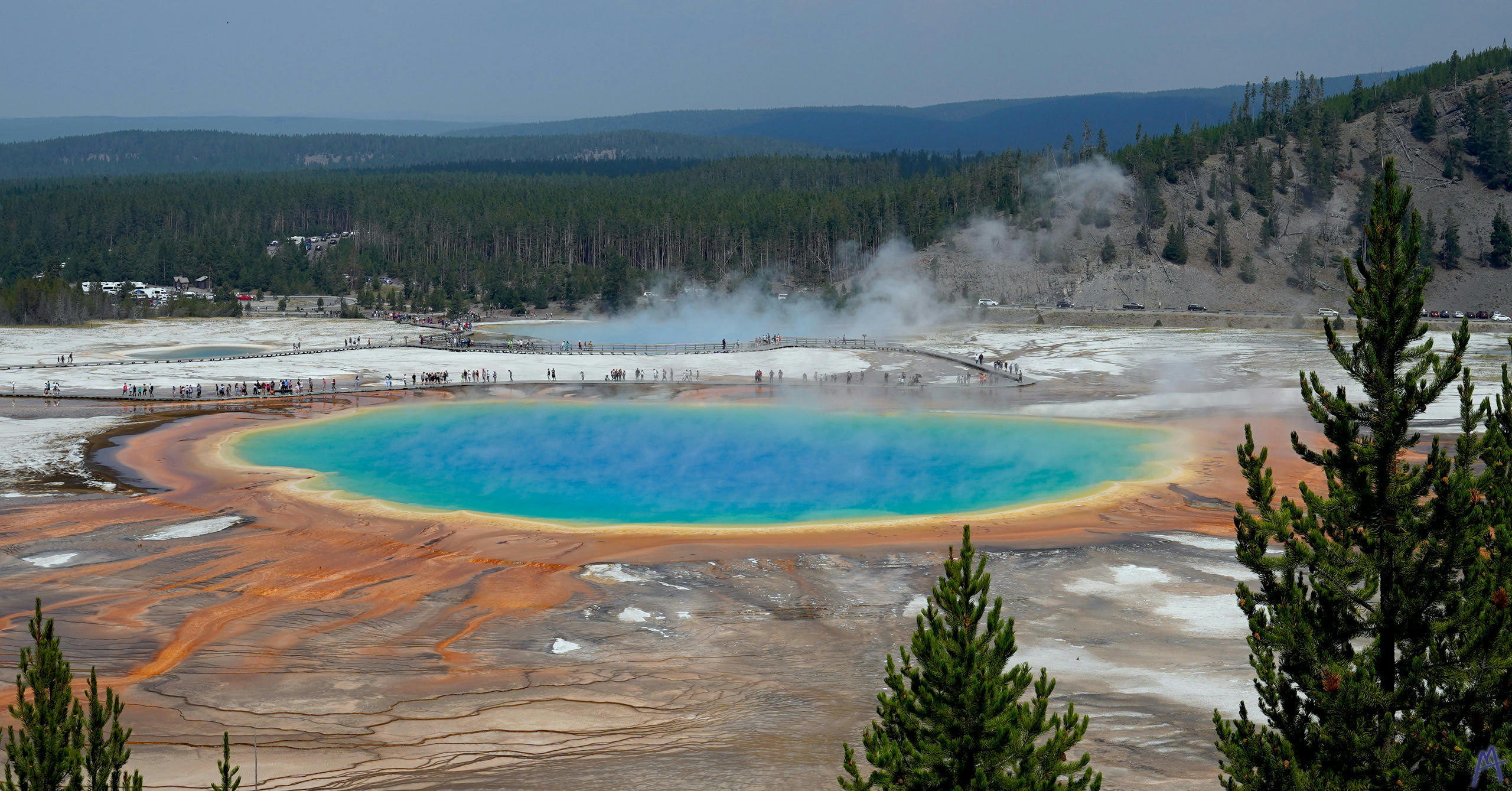 Deep blue, green, yellow, and orange Grand Prismatic Spring from above Yellowstone