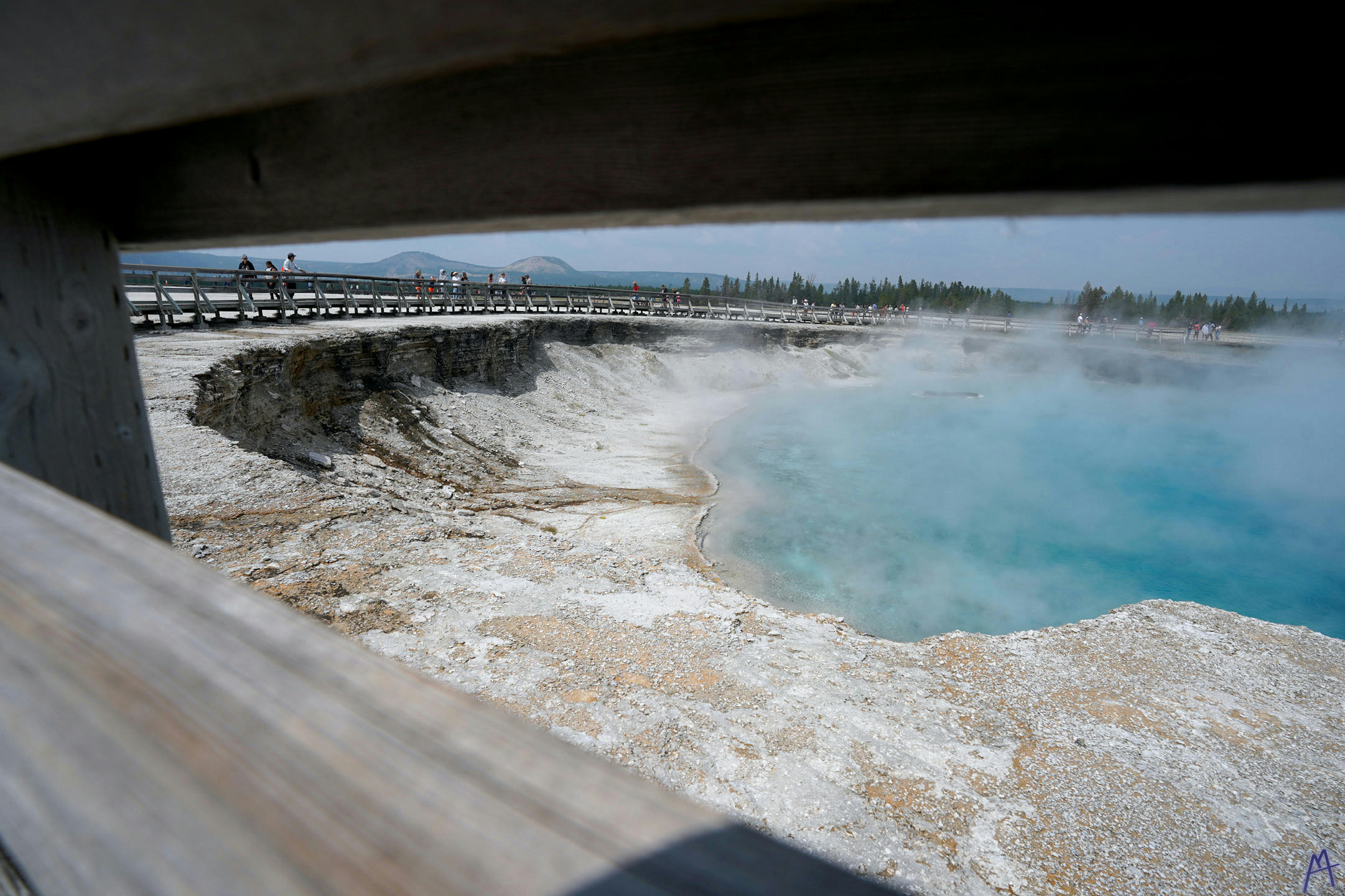 Very blue hot spring with steam at Yellowstone