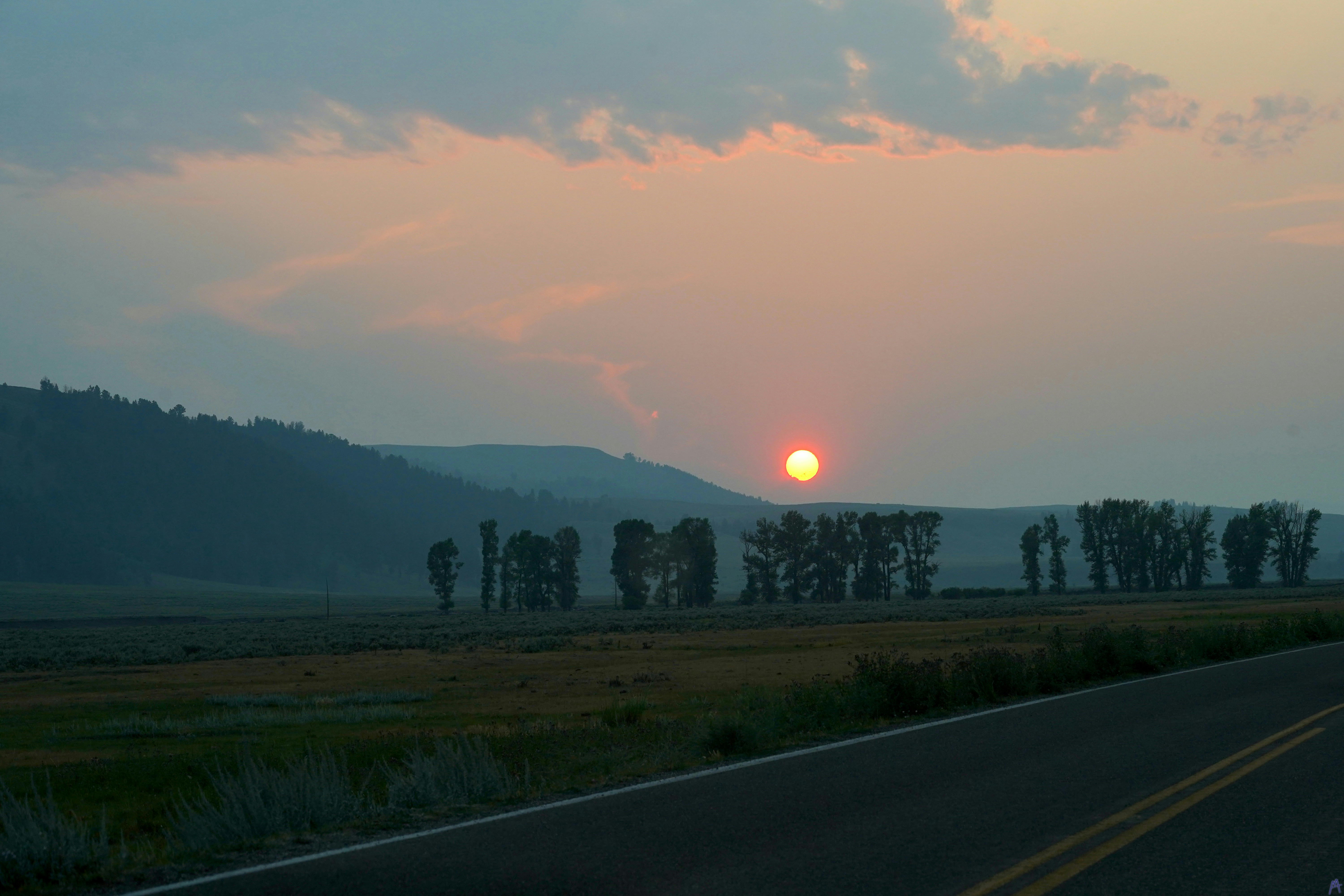 Orange sunset from road at Yellowstone