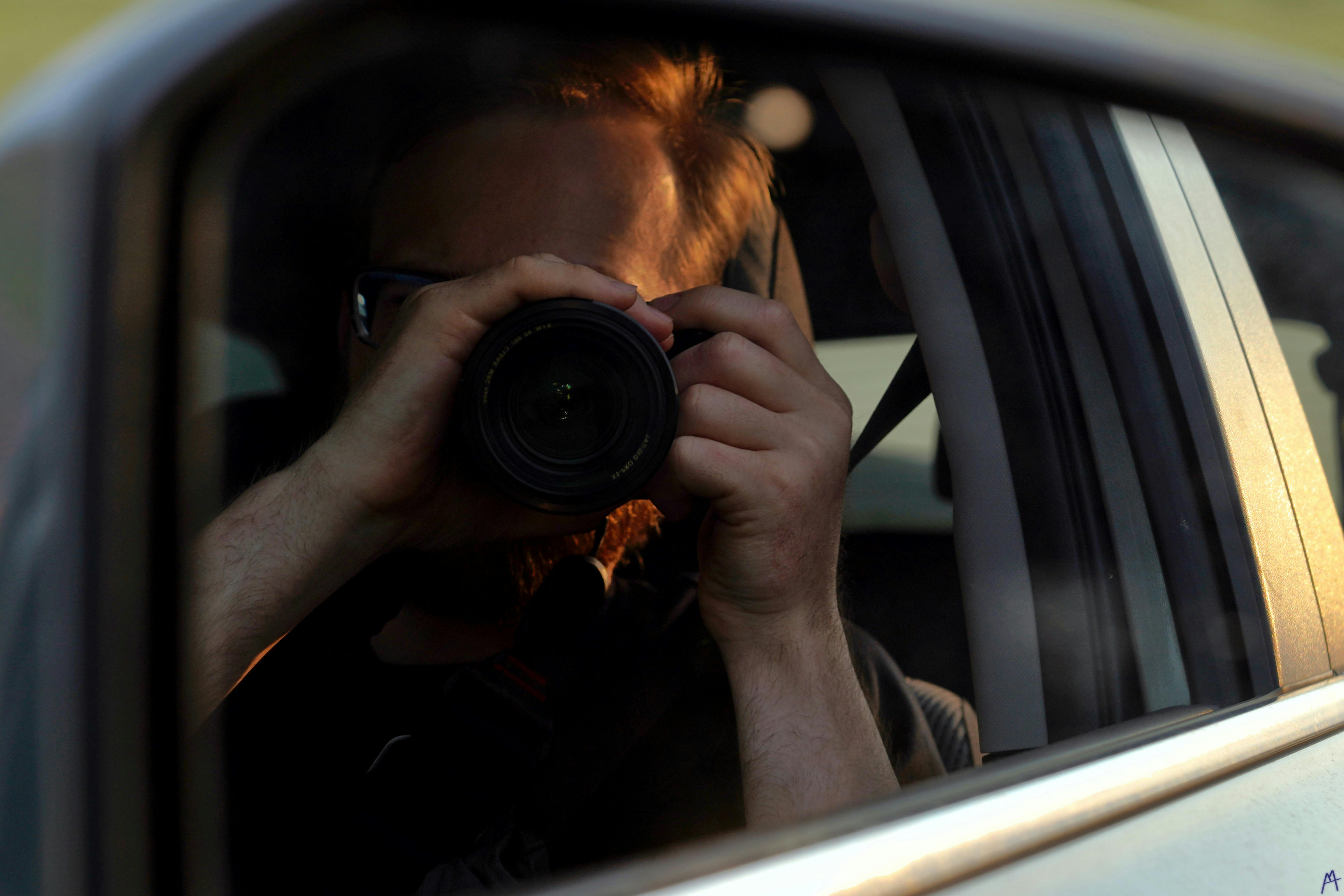 A photo of me, Matthew, reflected off of a car mirror at Yellowstone