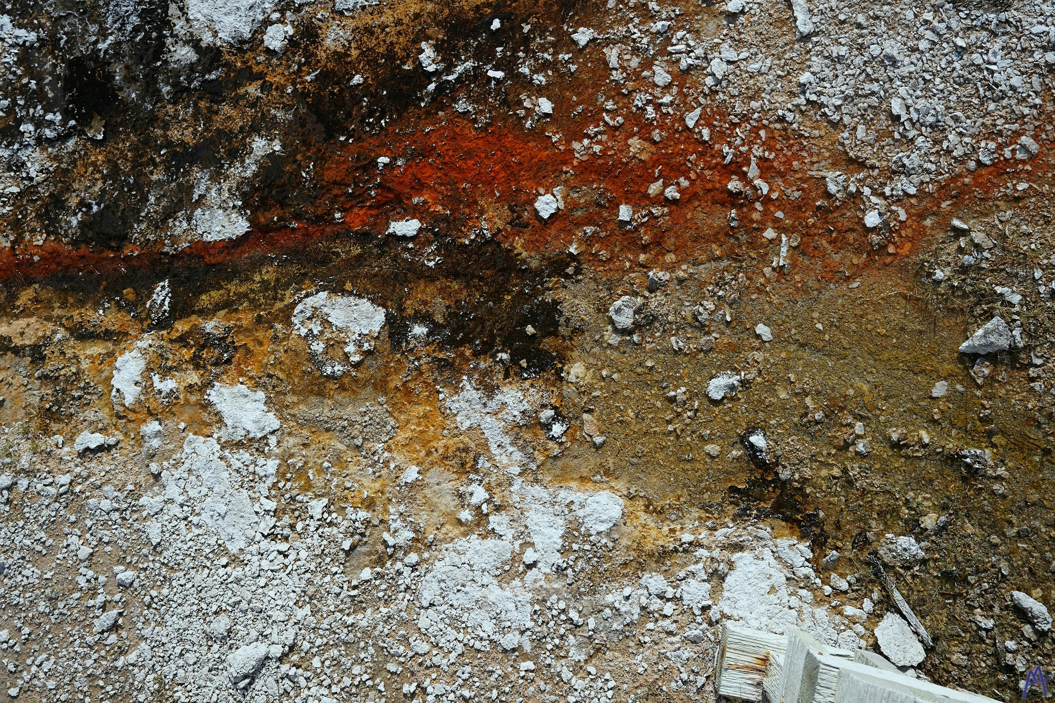 Orange black and stony hot spring runoff at Yellowstone