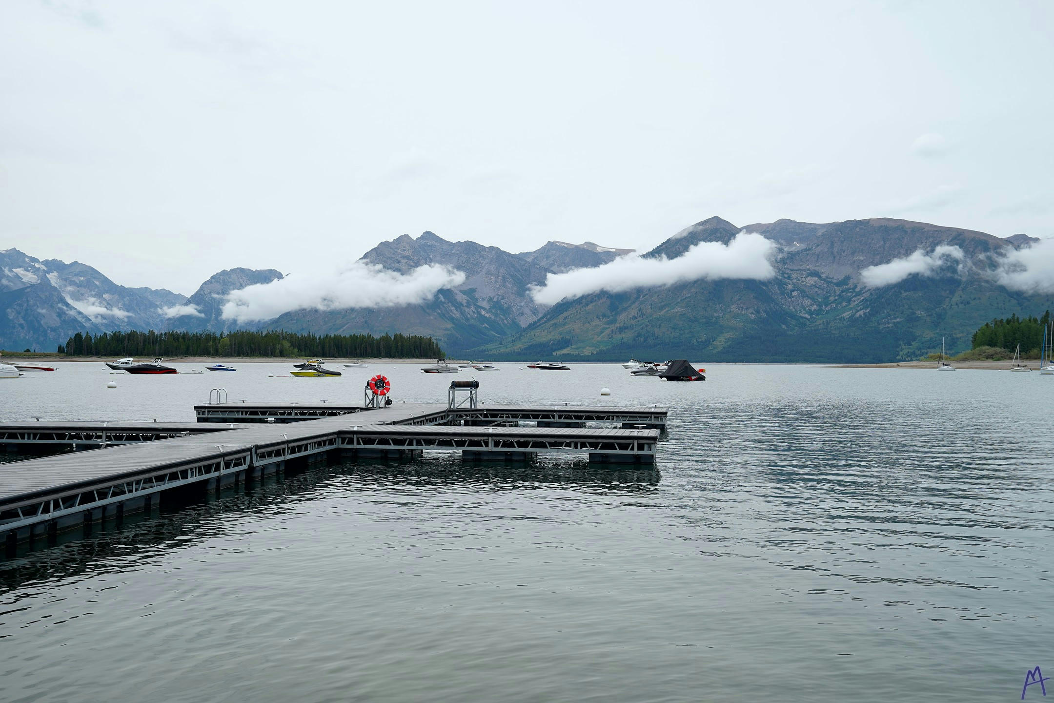 Dock with many boats in lake at Grand Teton