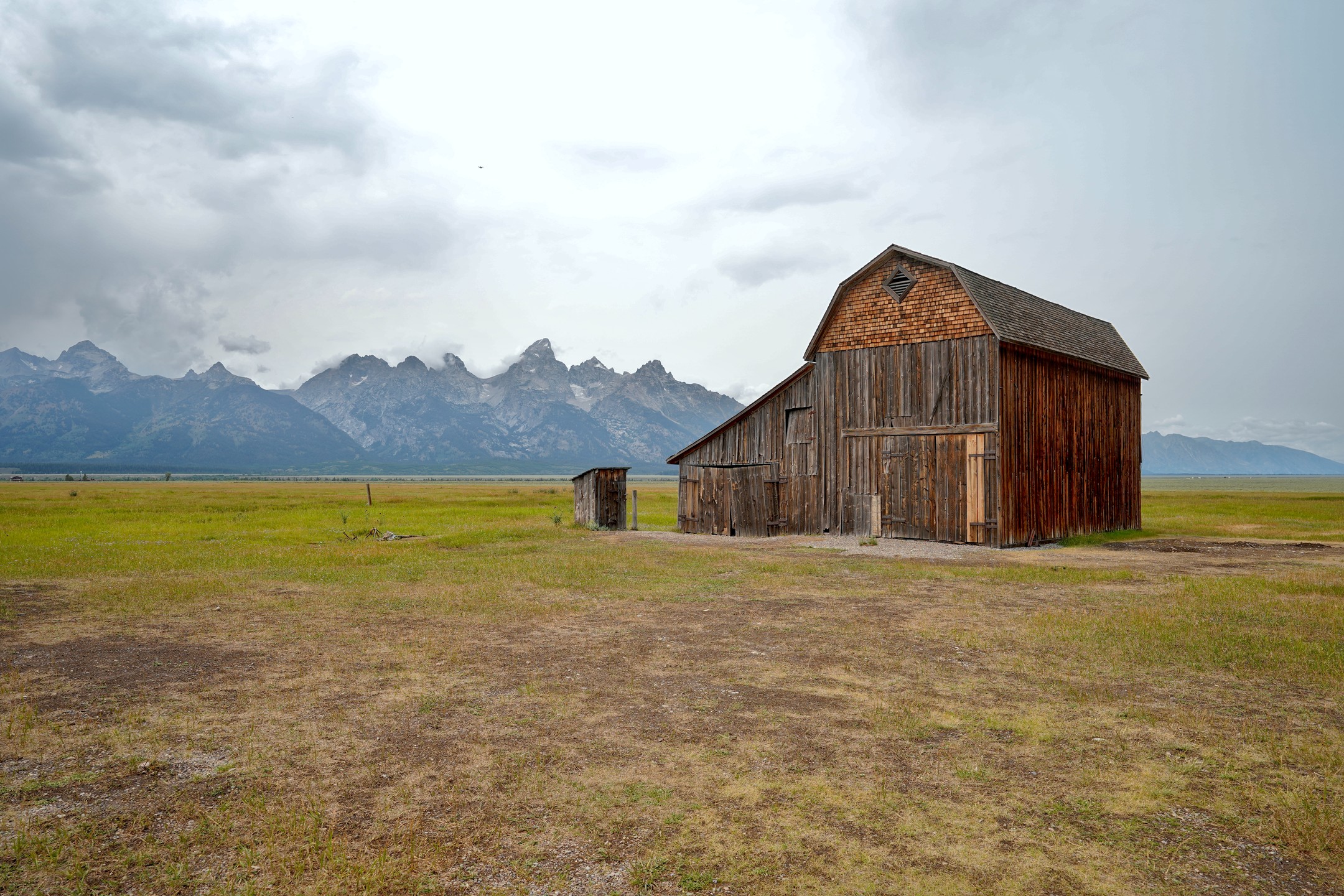 Barn and outhouse in grass at Grand Teton