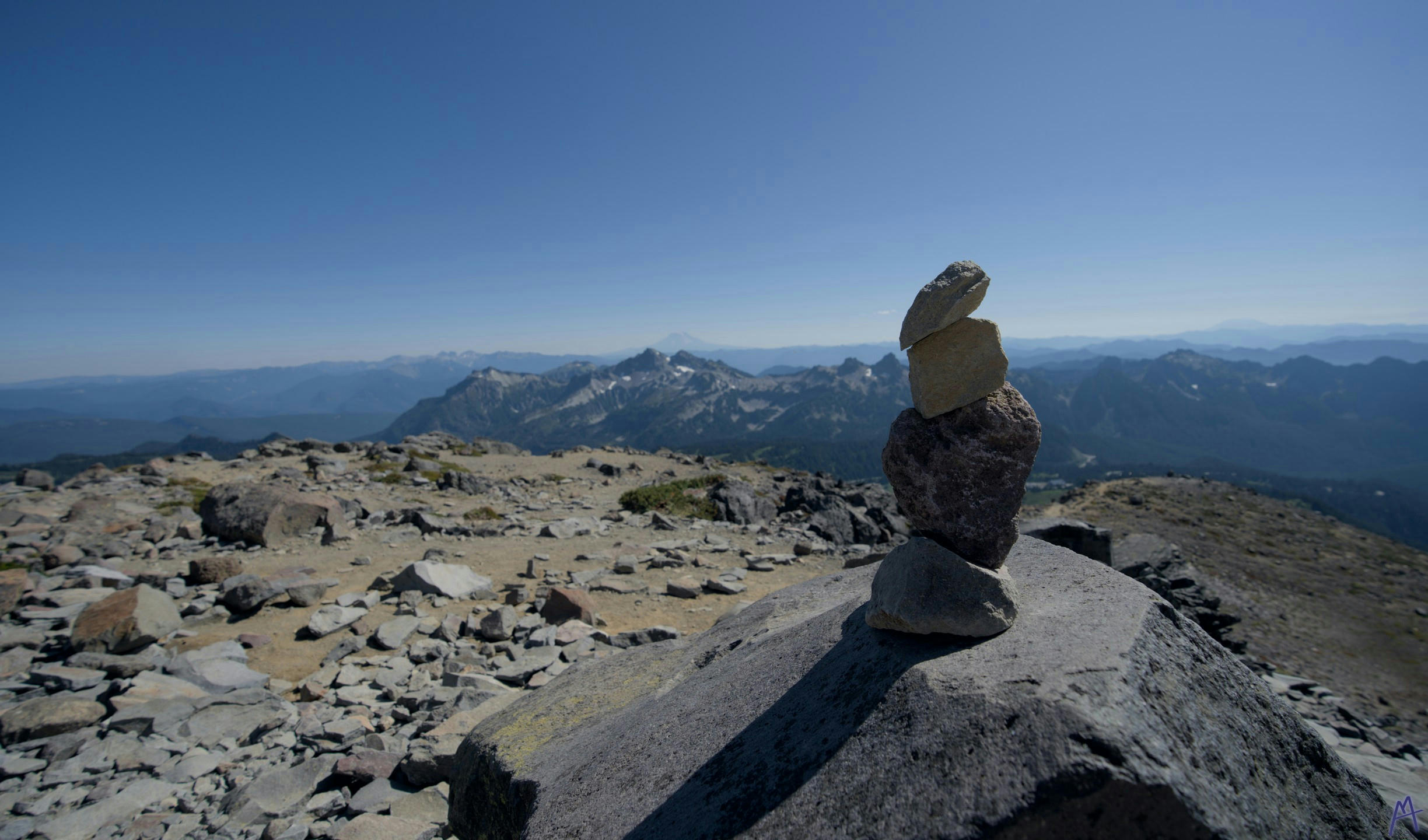 Pile of rocks near the horizon and cliff at Rainier