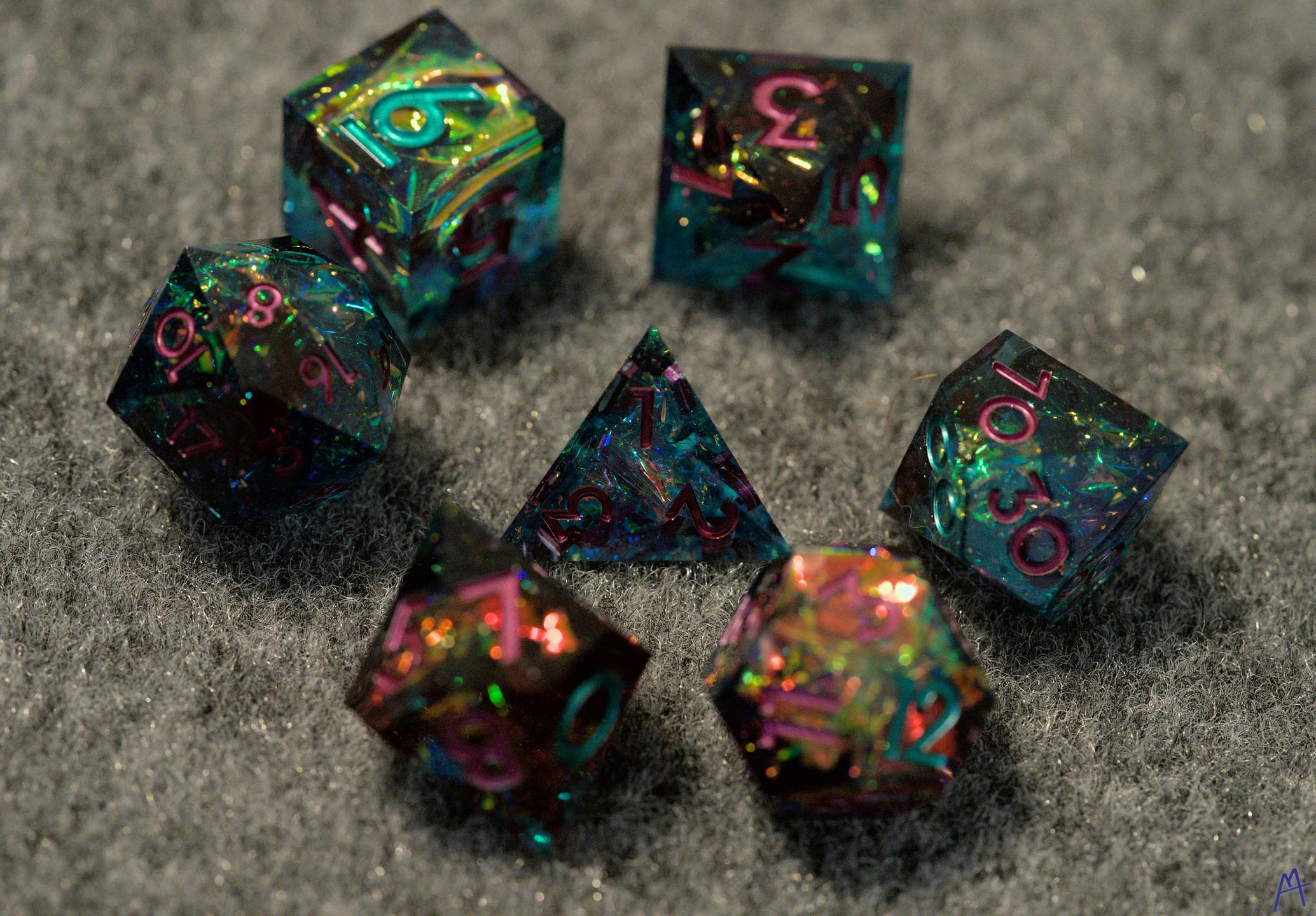 Green and purple dice on table