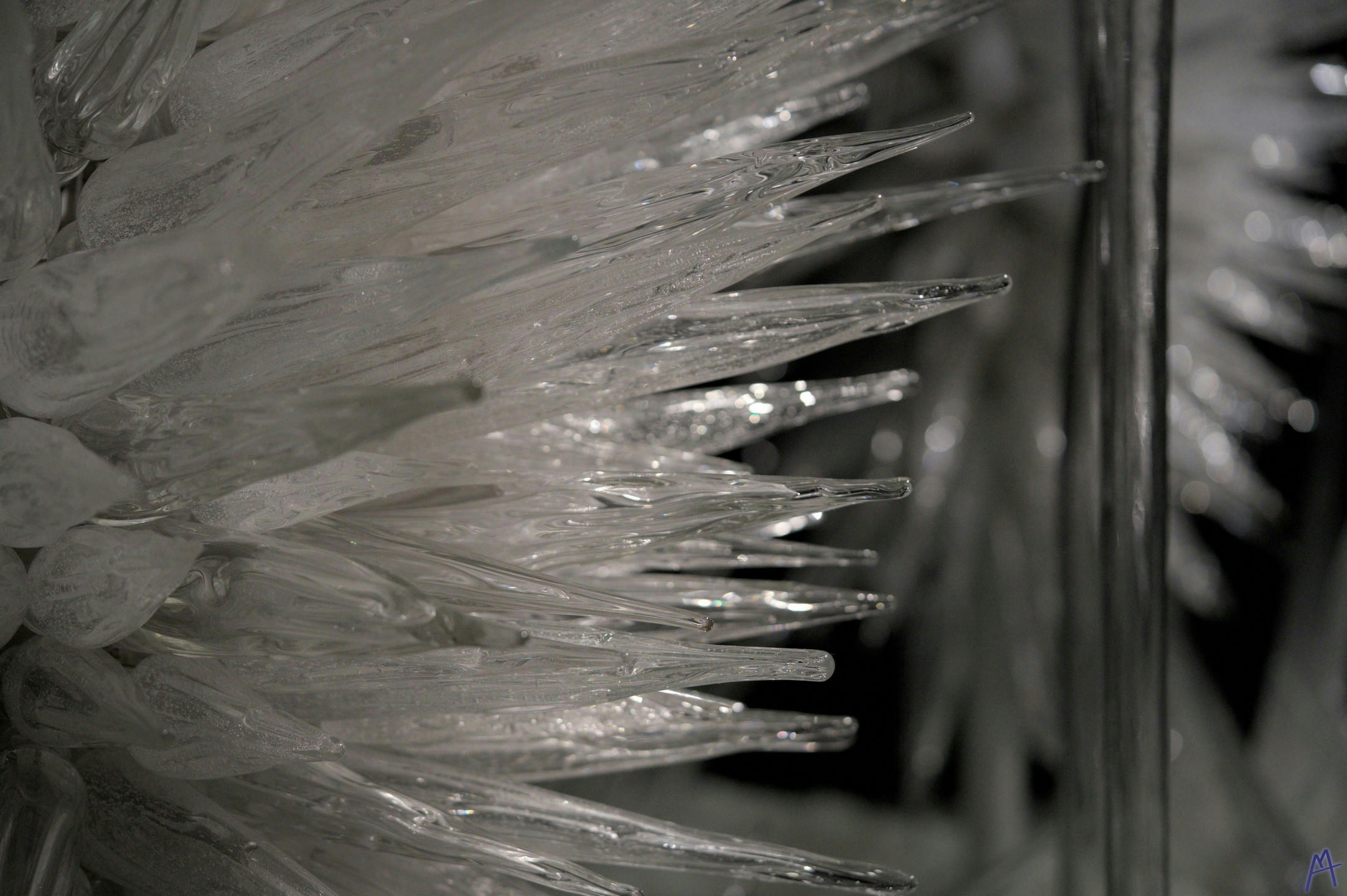White spiky glass needles near a glass poll