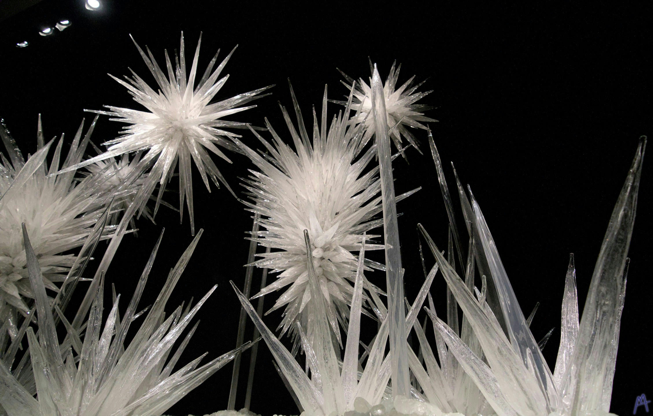 White spiky glass needles floating up into the dark
