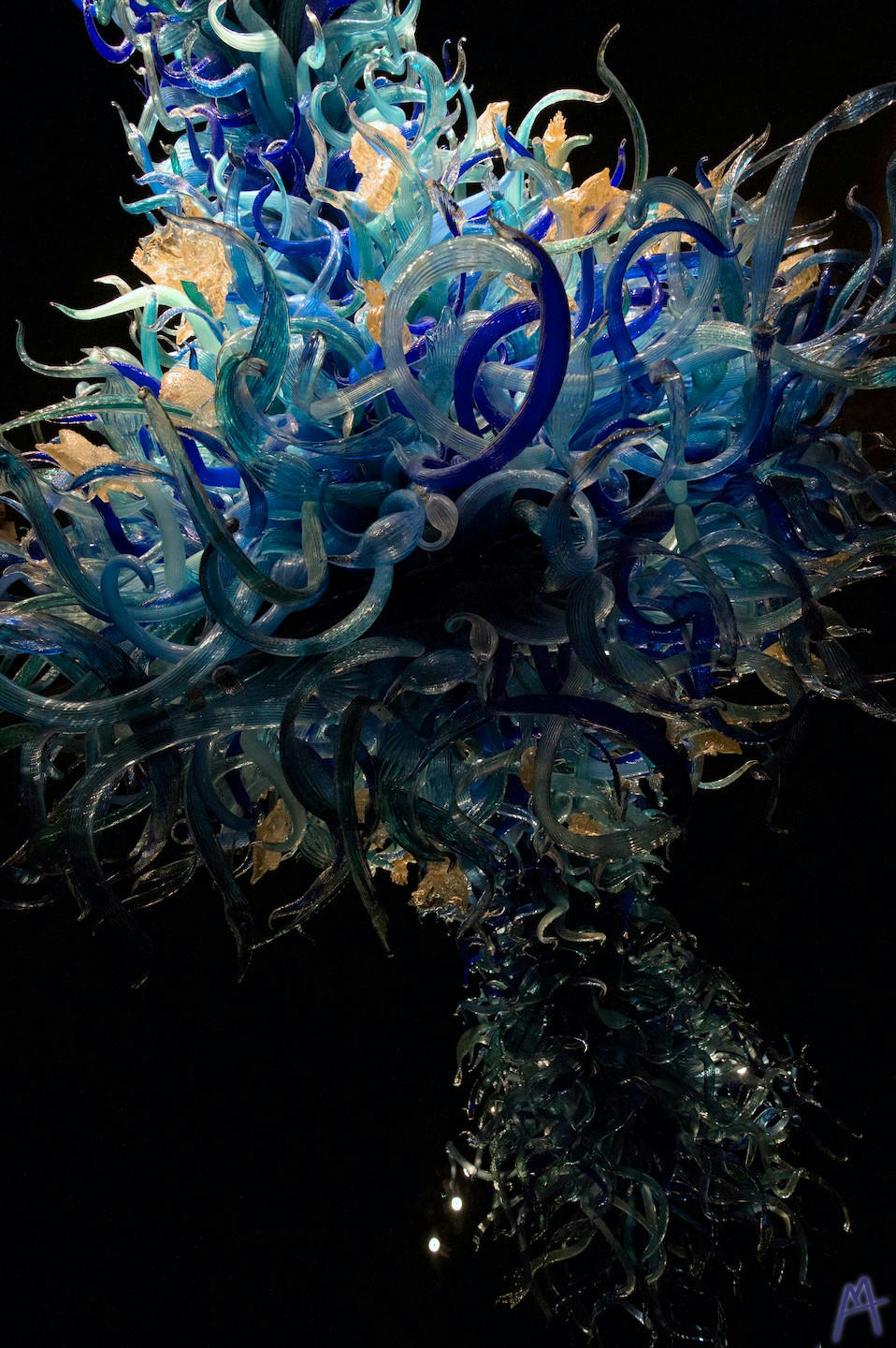 Blue and yellow glass statue and it’s black shadow