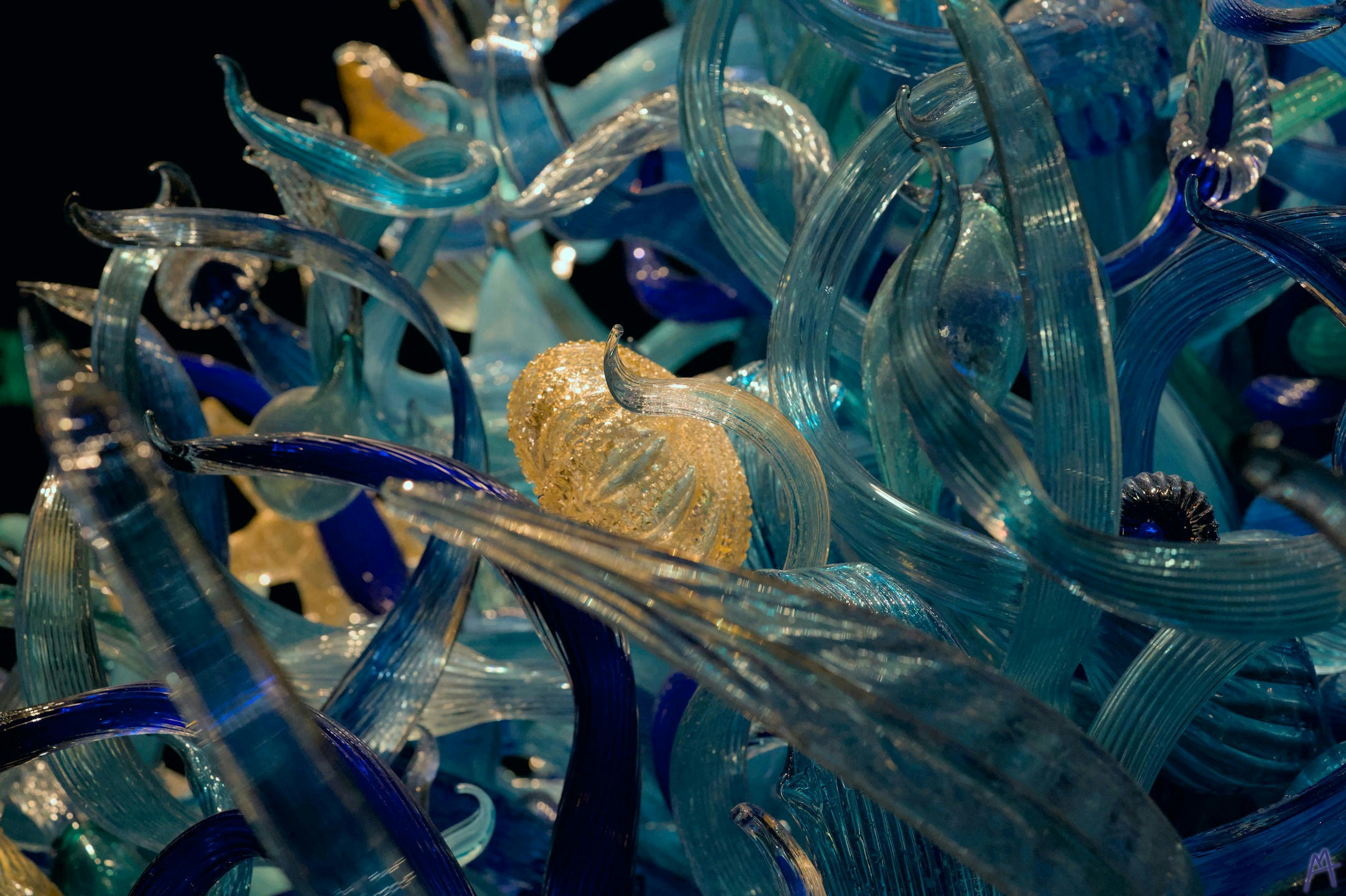 Yellow sea urchin in blue glass statue
