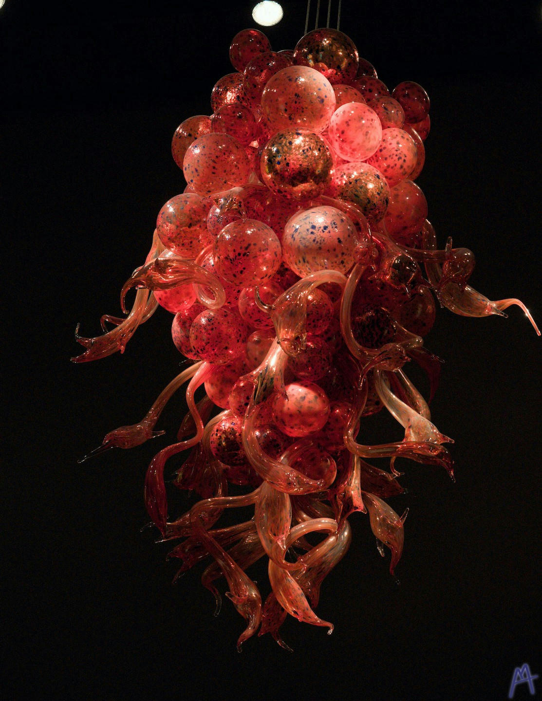 Red and black glass sculpture hanging from ceiling