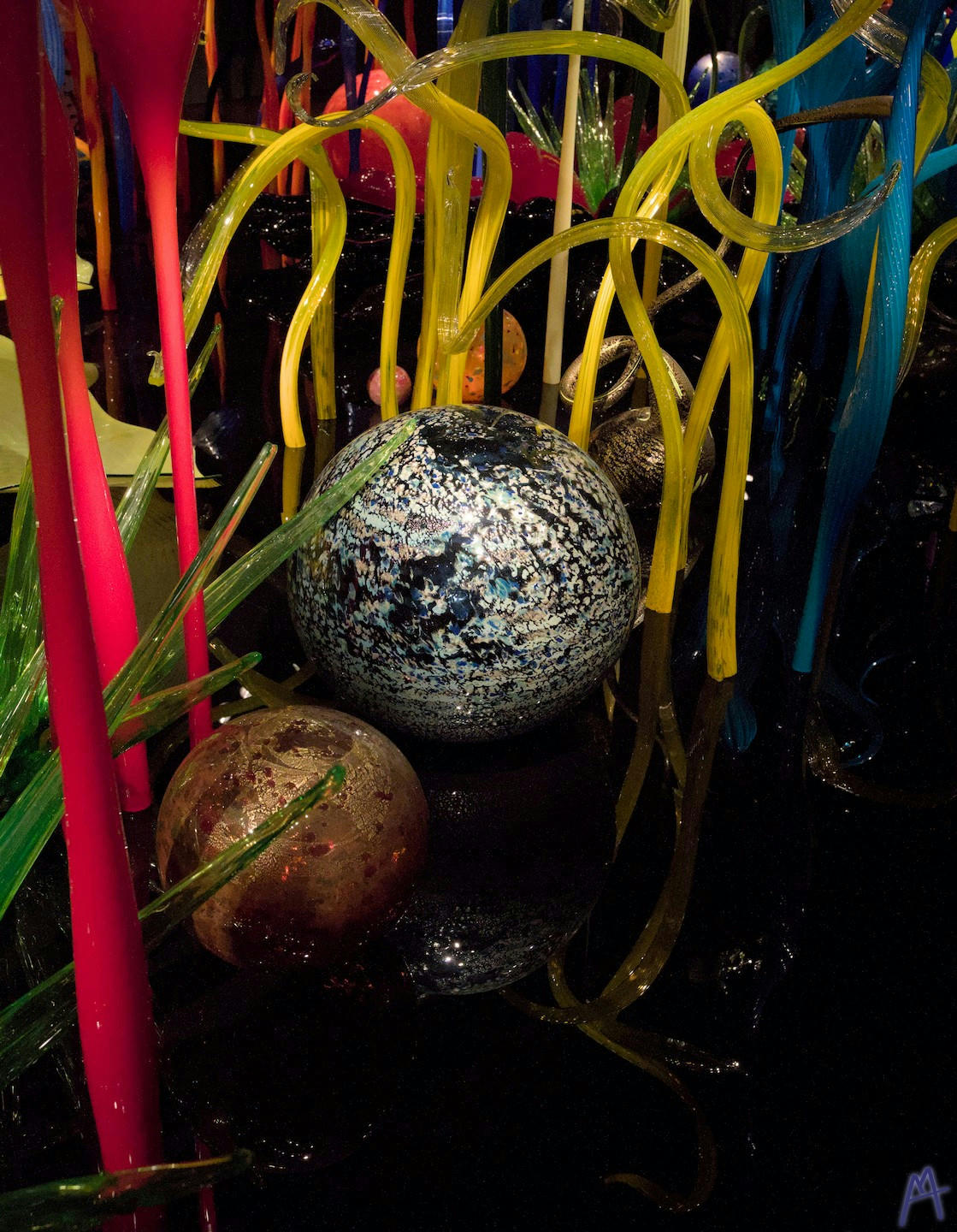 White and blue glass ball in glass forest